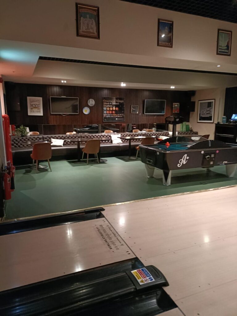 Games area with pool table, lounge seating and framed pictures