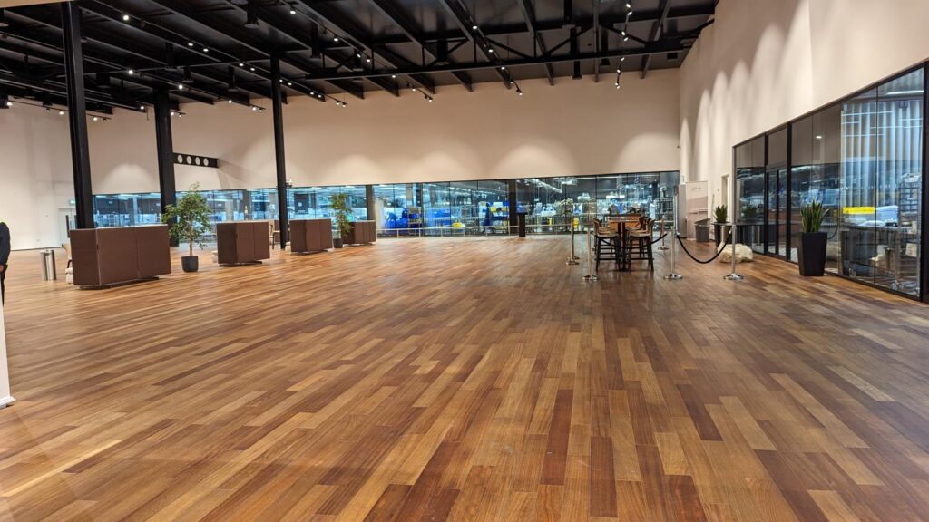 Large open-plan hall with timber floor and glazed walls
